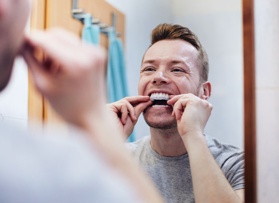 Man inserting mouthguard