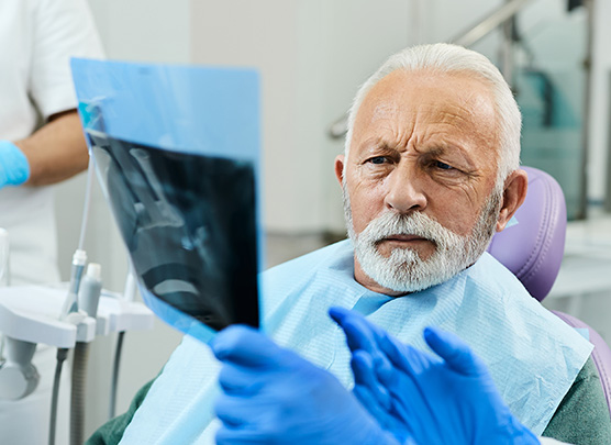 Showing dental x-ray to patient
