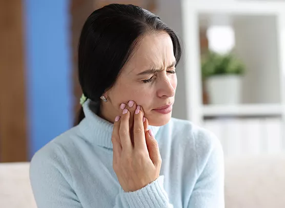 Woman experiencing jaw pain
